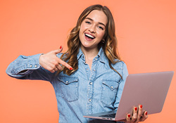 happy lady pointing at laptop