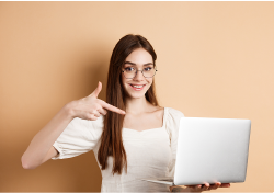 happy lady pointing at laptop