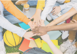 Diverse student people stacking hands together sitting outdoors at college campus